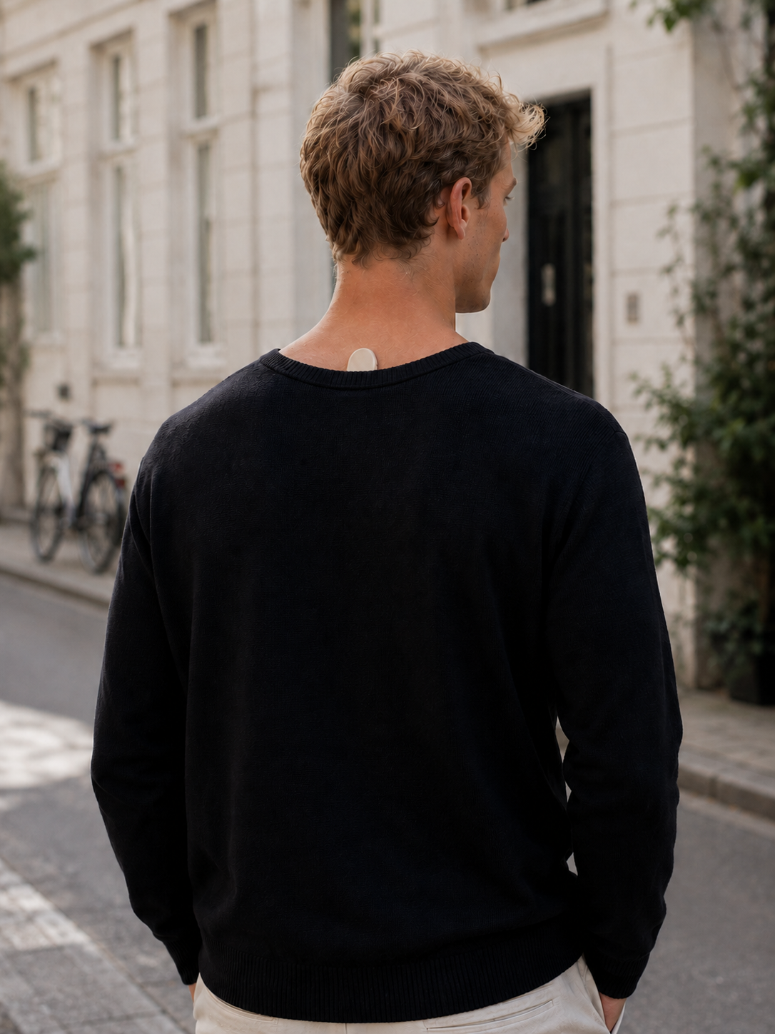 Oku device visible under a sweater during everyday outdoor wear