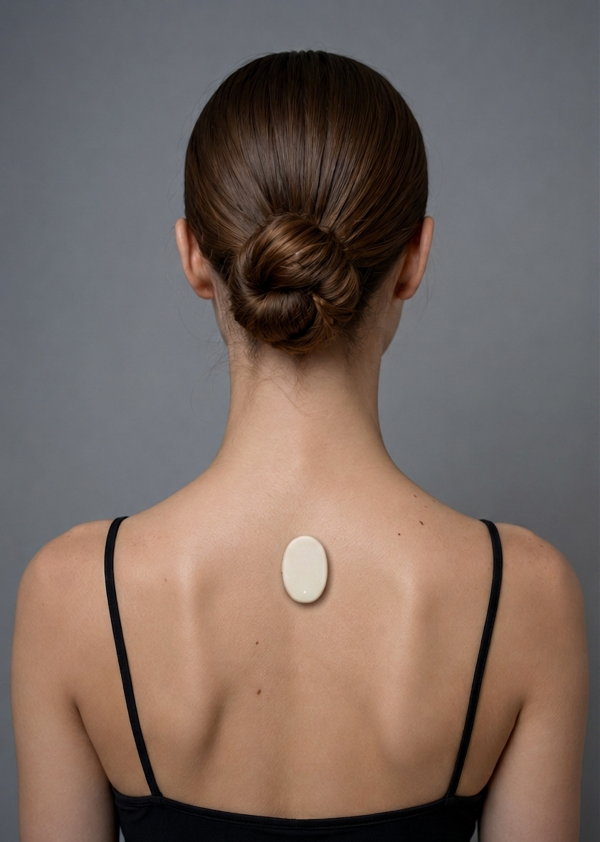 Oku device worn on the upper back with thin black straps